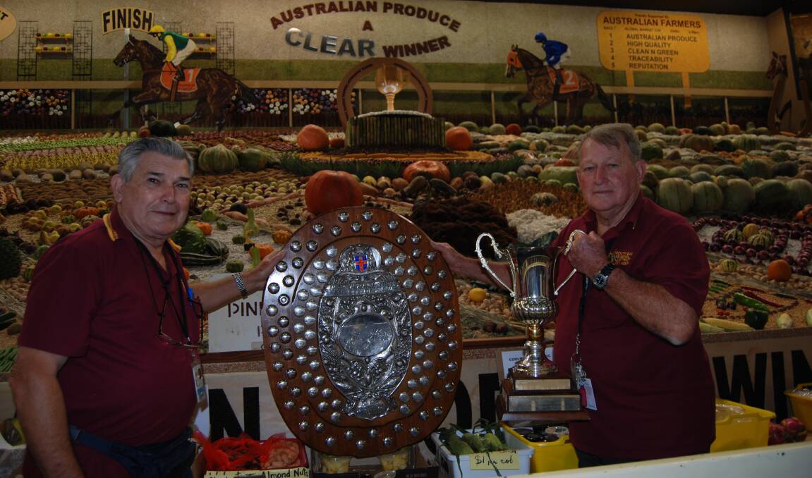 Les Dabbelsteine, Brisbane, and his brother Col, Glasshouse Mountains, Queensland, with the trophies for the best district exhibit.