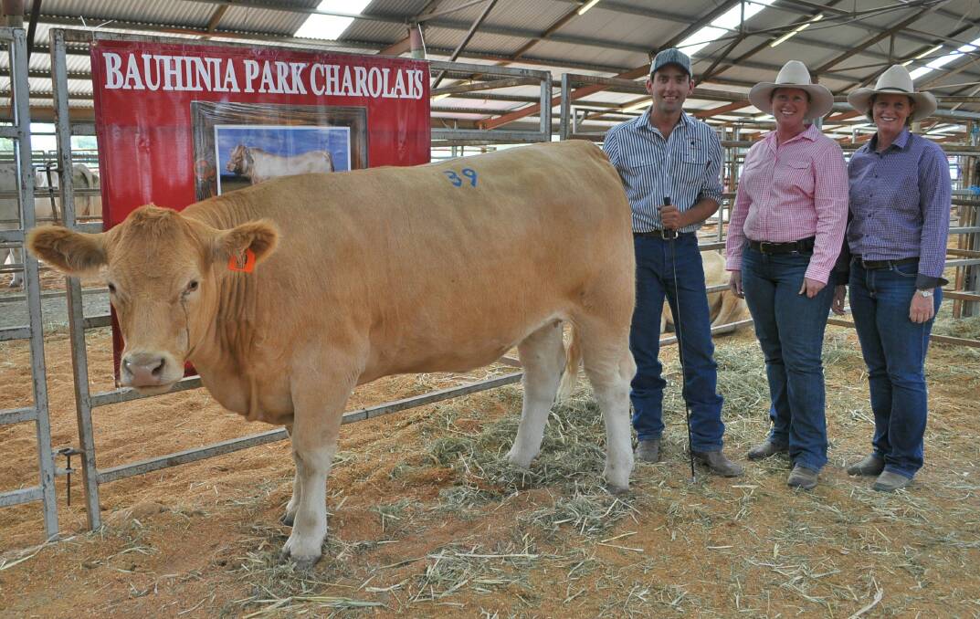 Ryan Holzwart, Bauhinia Park Charolais, Clermont with buyers Tania and Nicole Hartwig, Tanic Charolais, Monto who paid $6500 for the top priced heifer Bauhinia Park Fancy (P) (R/F).