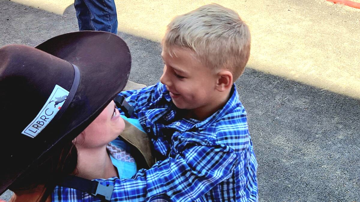 Rae Snider gets a hug from her son after her ride at the Ponoka Stampede, PIcture: Sally Gall