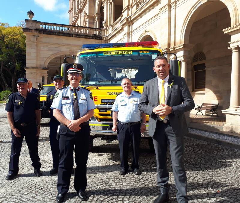 Members of the Toorbul Rural Fire Brigade and RFBAQ president Ian Pike outside Parliament House with Assistant Commissioner John Bolger and Fire and Emergency Services Minister Craig Crawford. Pictures supplied.