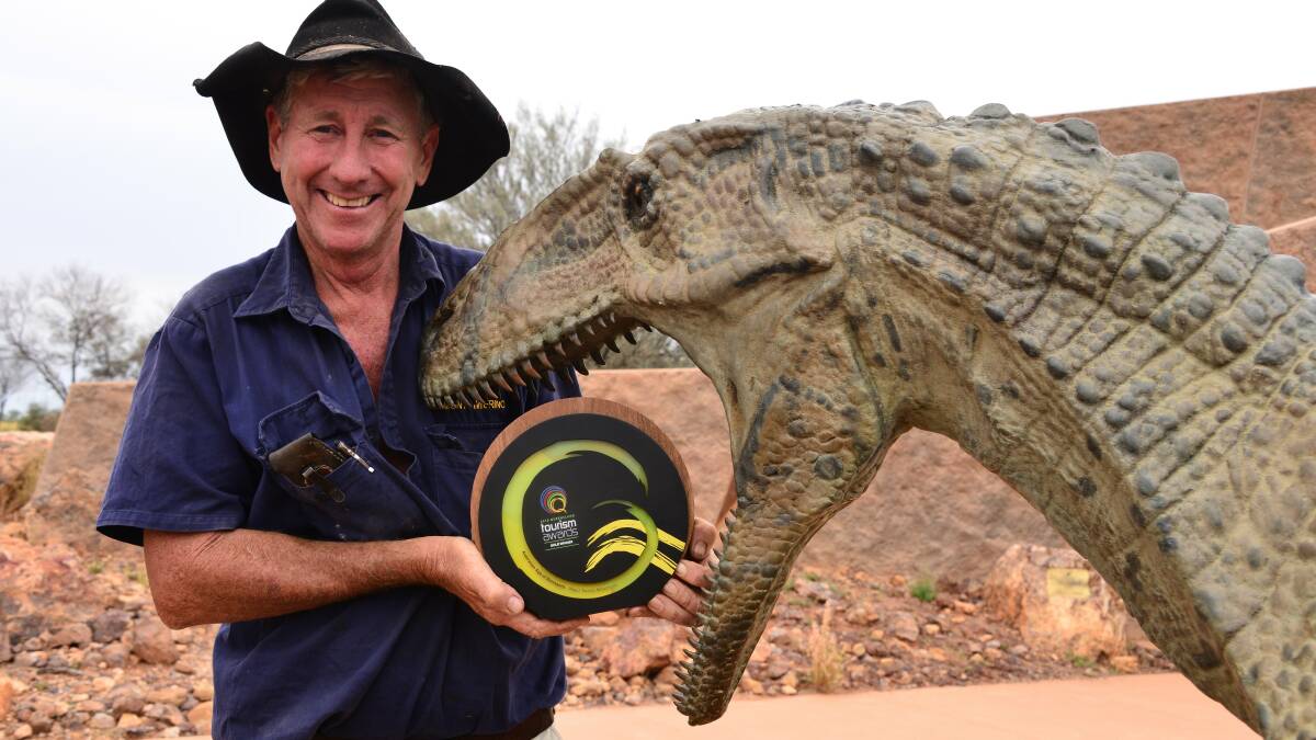 Fulfilling: Australian Age of Dinosaurs founder David Elliott had a tasty mouthful for his replica dinosaur when Winton mayor Butch Lenton returned on Saturday with the Queensland Tourism Award for Major Tourist Attraction of 2016. Picture: John Elliott.