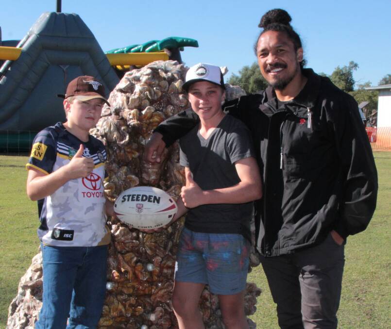 That's gold: Blackall's Drew Heumiller and Riley Hinds got to kick a ball around with rugby league legend Clinton Toopi.