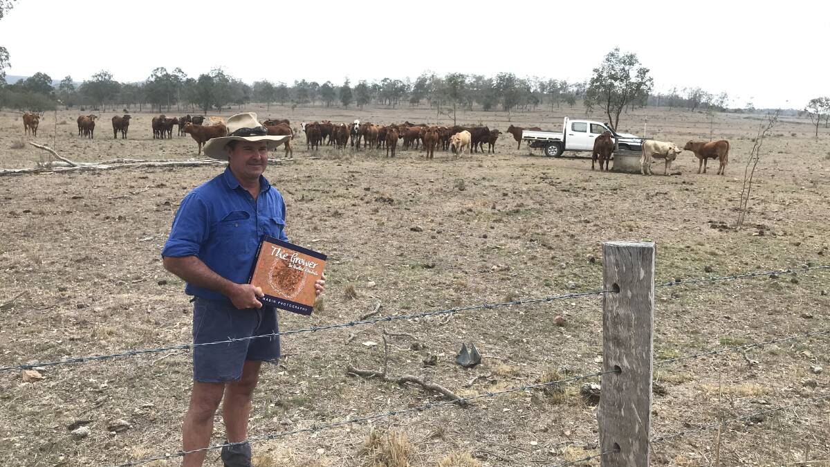 A central Queensland farmer receiving a copy of Alice Mabin's latest book.