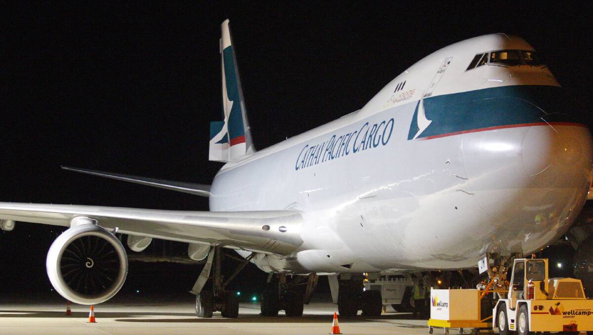 Loading up: Cathay Pacific Airways 747-8 being loaded with beef and mangoes at Brisbane West Wellcamp Airport on Tuesday night. Photo: contributed.