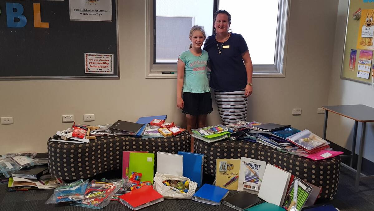 Chloe Hall and Quilpie State College principal, Rachael McWaters, and the school stationary donated from Maryborough. Photo supplied.