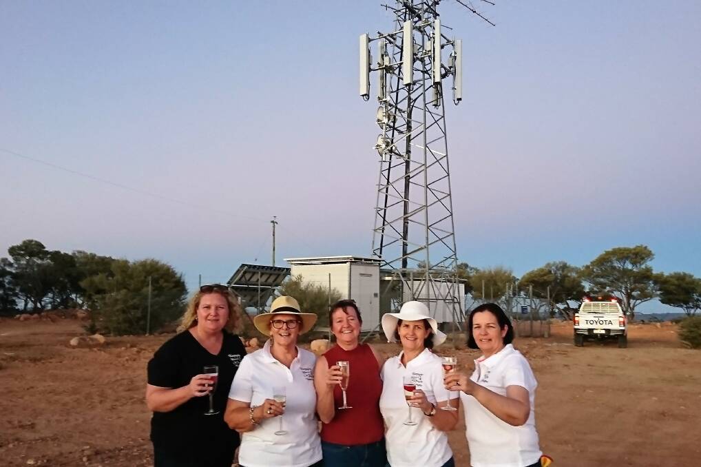 Cheers: Queensland Country Life senior journalist Sally Cripps (centre) helped toast the new mobile phone tower at Yaraka along with motivational speaker Helen Everingham and Longreach friends Rachel Bock, Liz Lynch and Jane Tinknell. Picture: Sally Cripps.