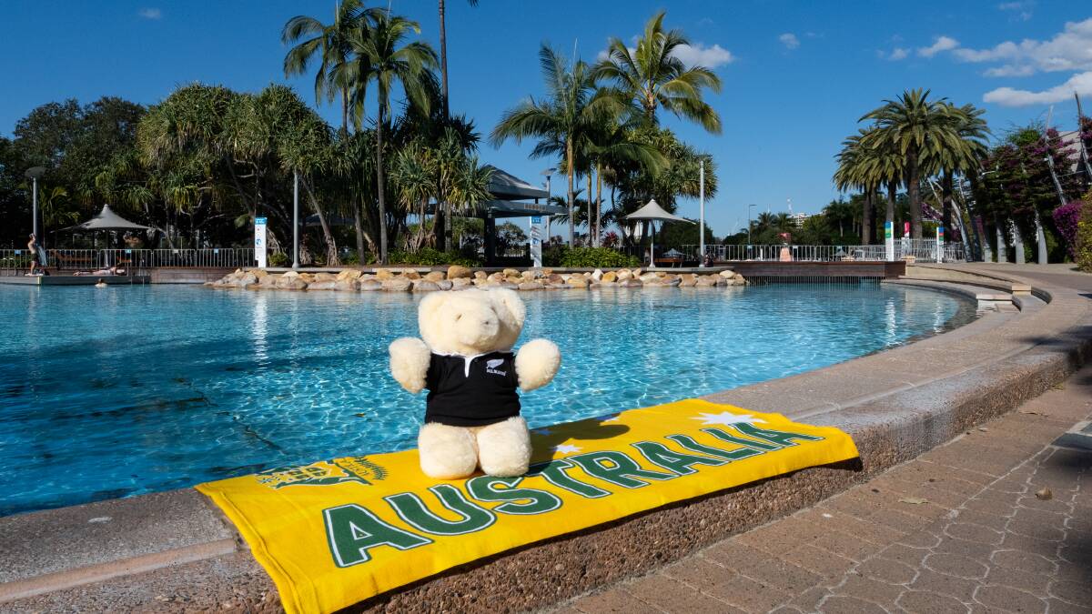 Tasman Teddy, decked out in his All Blacks jersey, poses at South Bank on an Australian towel before crossing the ditch to New Zealand for the first time. Photo: supplied