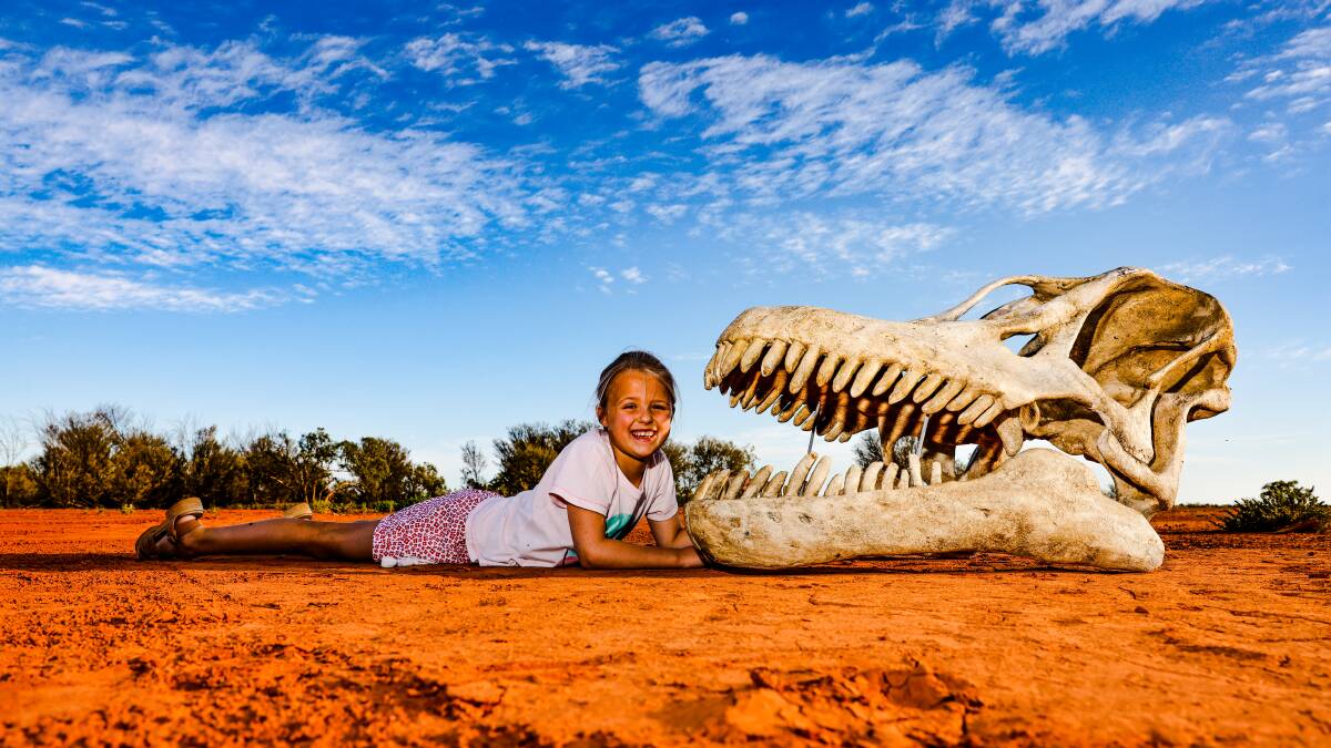 Quilpie's Georgina Grimm faces off with the skull of Cooper, Australia's largest dinosaur. Picture: 
