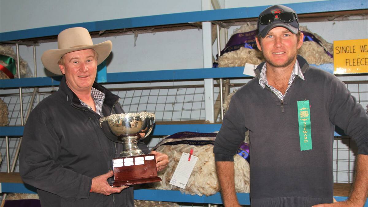 Scott Bredhauer, Lambert, Charleville presented with the wool pavilion aggregate trophy by steward Alister Macdonald.