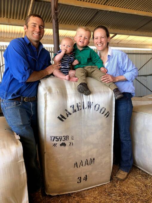 Andrew and Sally Hacker and their children Will and Charlie with bales from their first shearing at Hazelwood, west of Isisford in Queensland's central west. Picture supplied.