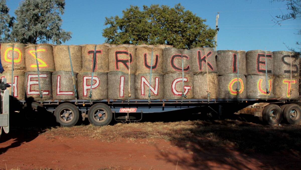 "Oz Truckies helping out" - the sign says it all to passers-by as the Hay Runners spread their message of support throughout regional Australia on a canvas of hay.