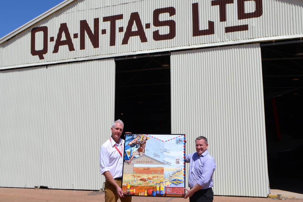 Qantas Founders Museum CEO, Tony Martin, and CQUniversity associate vice-chancellor (Central Highlands), Blake Repine, look over the artwork ‘Letter from Longreach’ that was painted by CQUniversity art collection manager, Susan Smith.