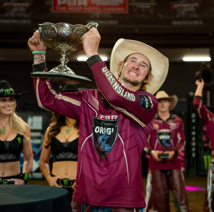 Aaron Kleier holds the PBR Origin trophy aloft for the cheering crowd in Cairns on Saturday.