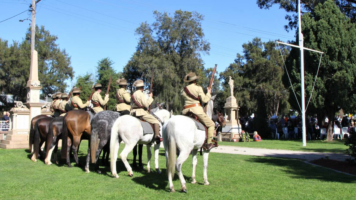 Re-enactment troops face the Boer War memorial in Allora, the first erected in Queensland to honour the fallen from that conflict.