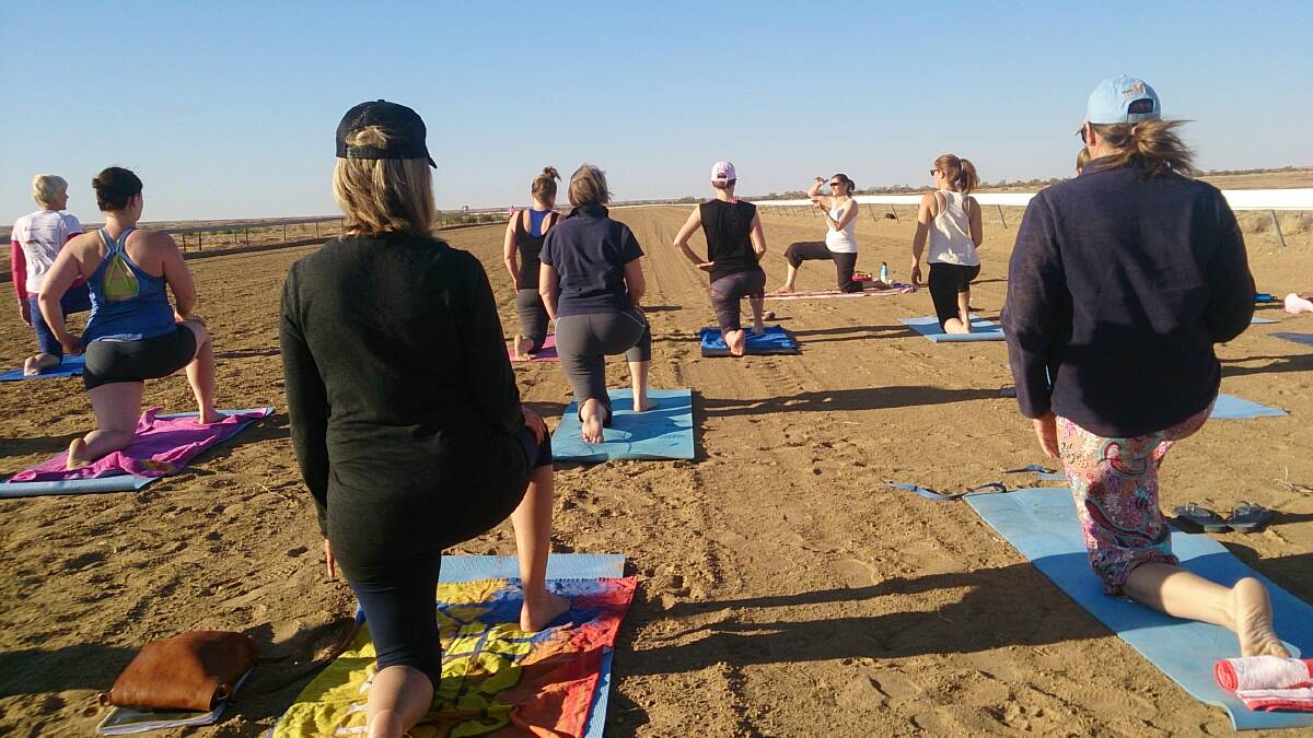Early morning yoga on the Betoota racetrack at the 2014 Channel Country Ladies Day.