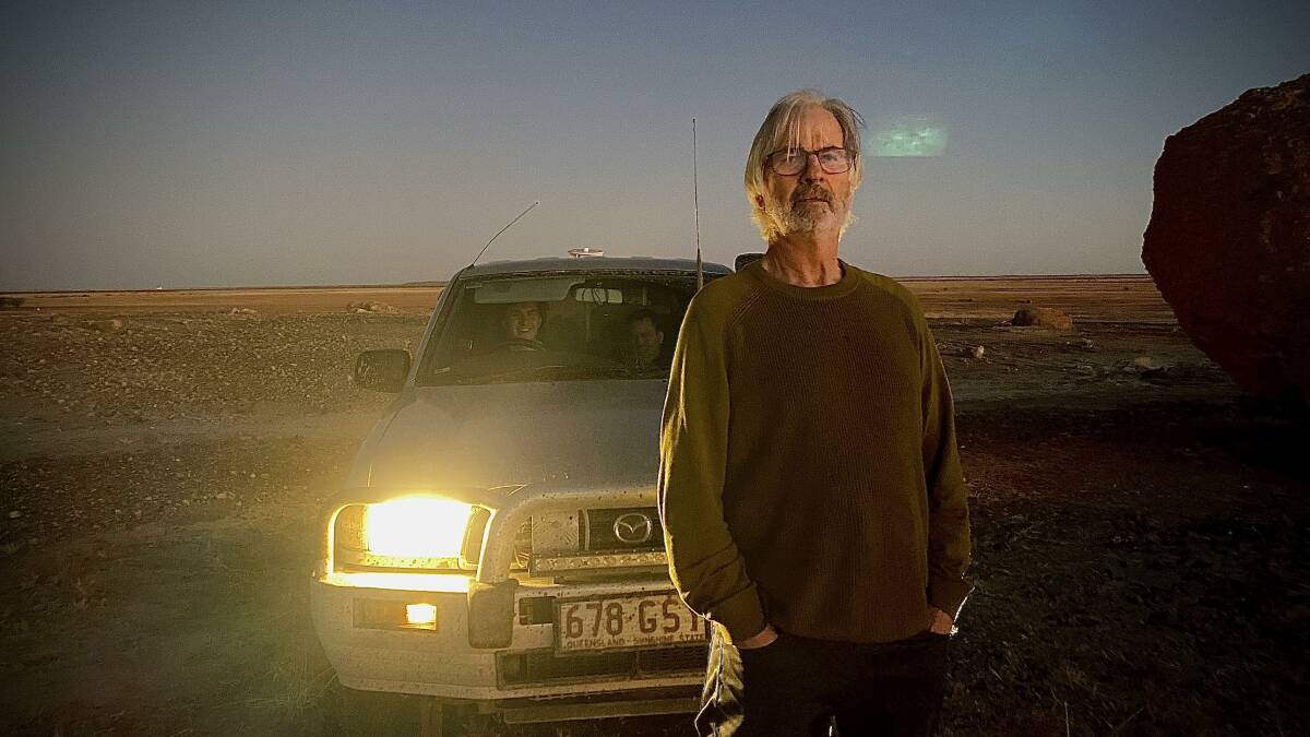 John Jarratt manages to recreate his creepy Mick Taylor persona on the outskirts of Winton during the Vision Splendid Outback Film Festival, with the help of some car lights at dusk. Photo - John Elliott.