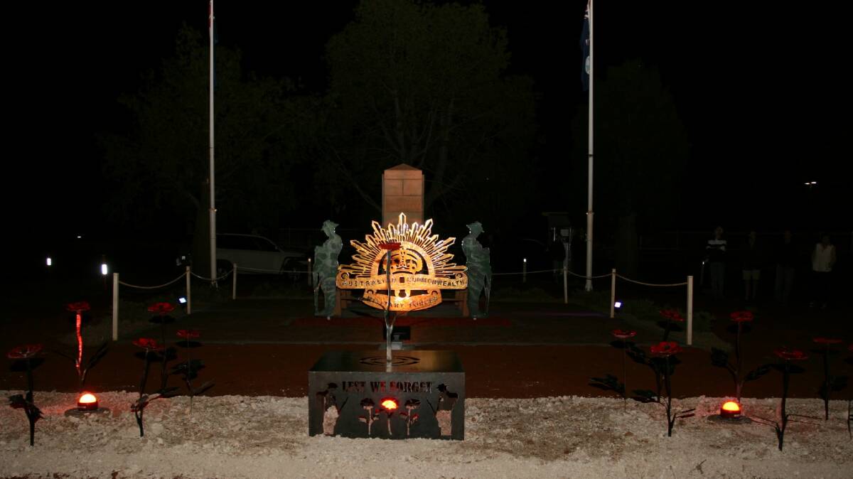Lighting revealed the stunning military forces insignia at Morven's cenotaph in the lead-up to Anzac Day 2021. Photo - Annabelle Brayley.