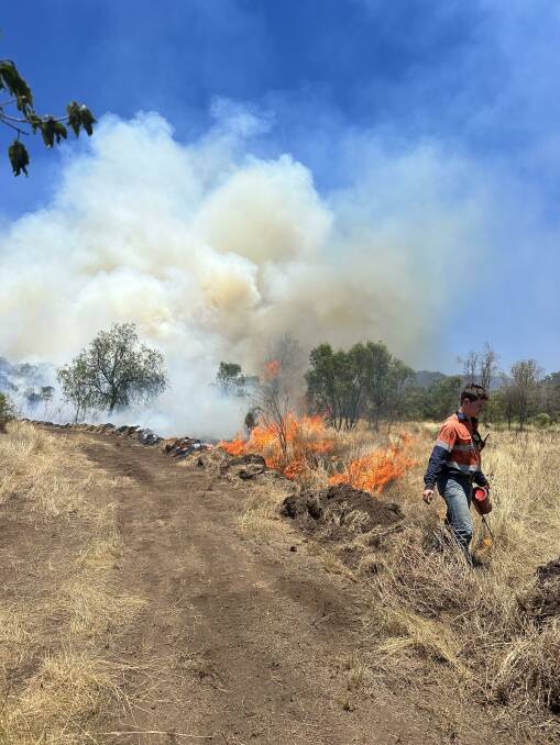 A volunteer firefighter undertakes a backburning operation in the Springsure area. Picture: Rebecca Arniboldi