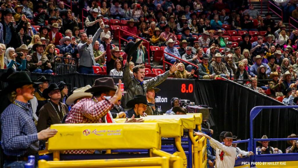 PRCA All-Around world champion Stetson Wright and saddle bronc rider Damian Brennan cheer on friend Ky Hamilton during the bull riding. Picture: PRCA