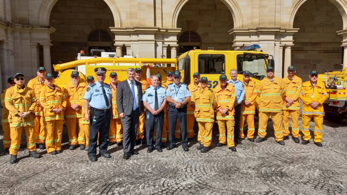 Emergency Services Minister Mark Ryan with Rural Fire Brigade members at Parliament House for the historic announcement. PIcture supplied.