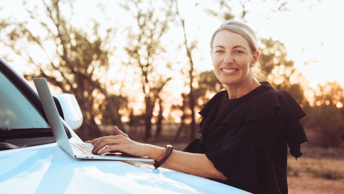 Elisha Parker at work on the bonnet of her car in rural Queensland. Picture supplied.