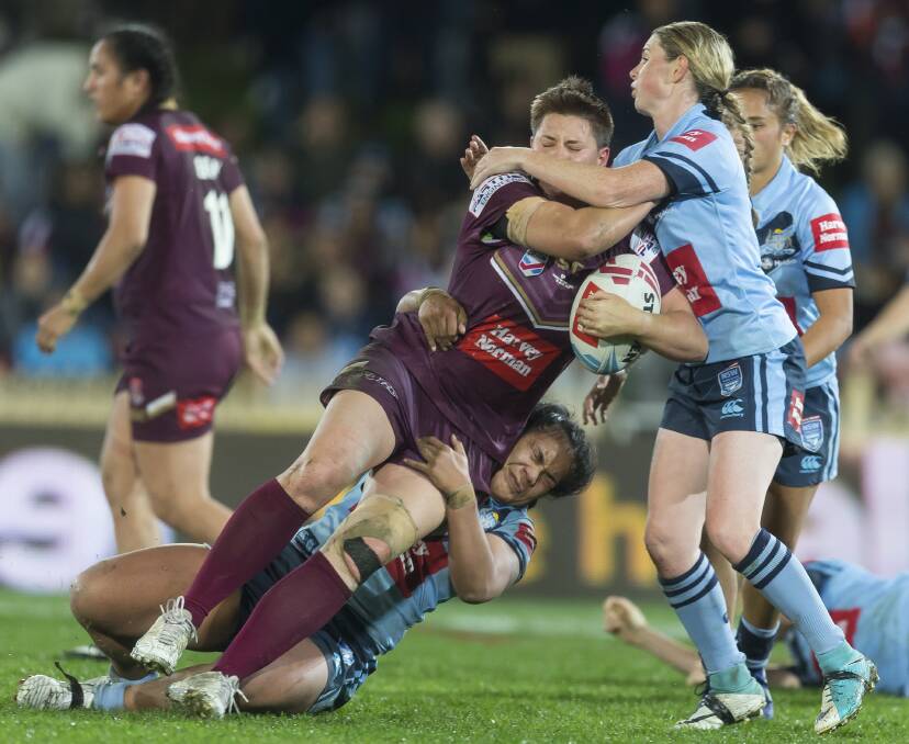 Heather Ballinger, playing for Queensland, being tackled in the inaugural women's State of Origin rugby league game at North Sydney Oval on Friday night. AAP - Craig Golding.