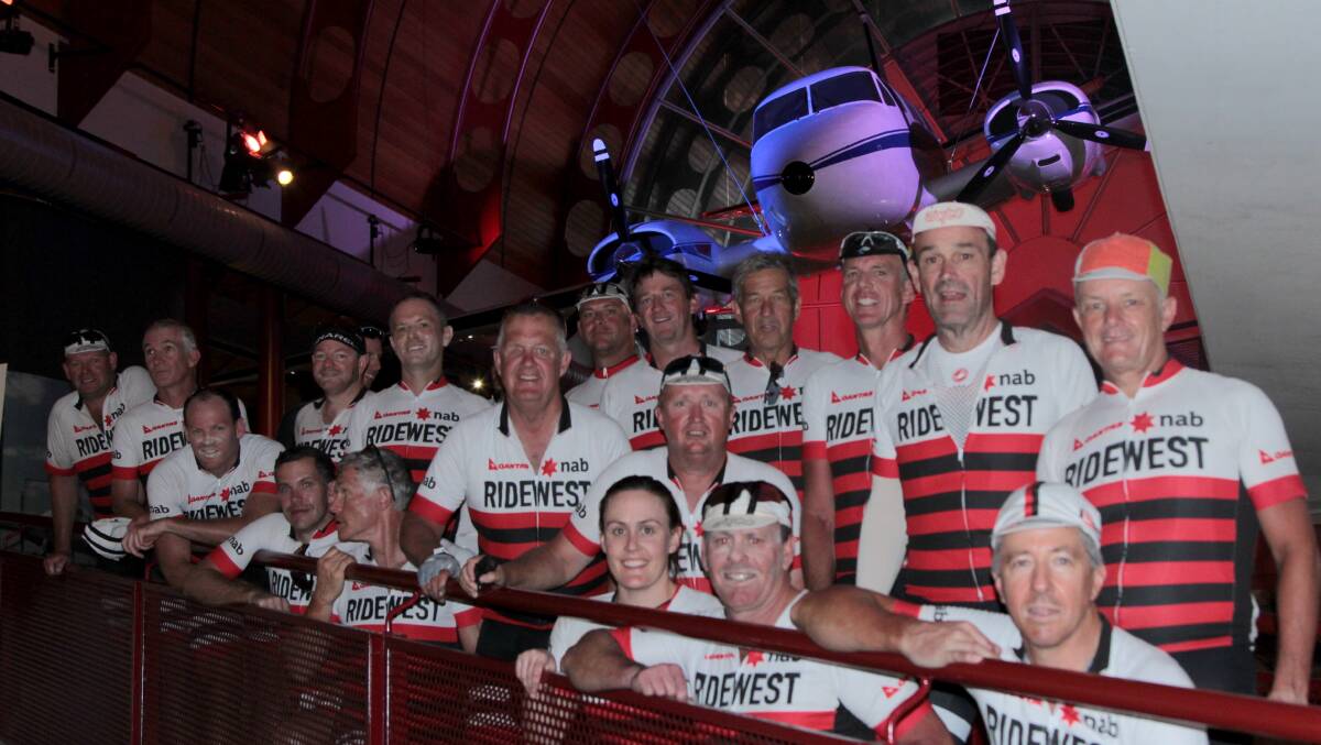 Marathon effort: Tired RideWest participants posing in front of the Royal Flying Doctors Service Queen Air hanging in the Australian Stockman's Hall of Fame at the end of their 1200km bike ride to raise money and awareness for RFDS mental health initiatives. Picture: Sally Cripps.