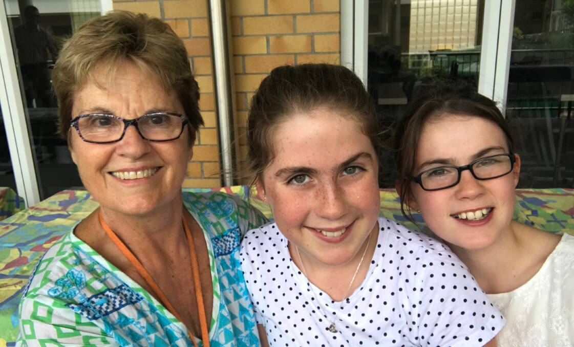 Retiring Clayfield College head of boarding Di Kerr, pictured with her grandaughters Olivia and Darcy, who are boarders at the college. Picture - Jessie Persse.