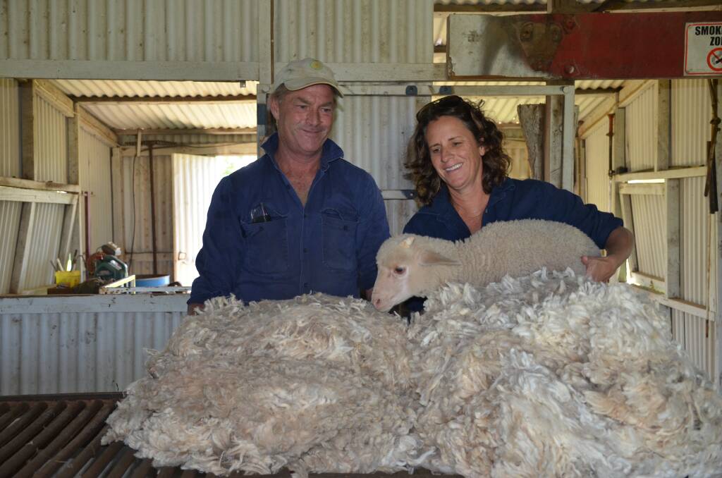 Ray and Edwina Cameron and a lamb with the wool they marketed under the global Responsible Wool Standard.