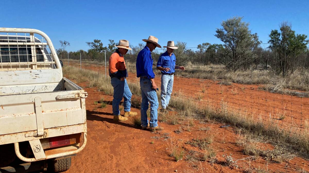 Dick O'Connell, Wombula Station, explains the construction of his privately funded exclusion fence to the Bulloo Shiree Council's rural lands officer James Theuerkauf and Thargomindah Station owner Adam Klein.