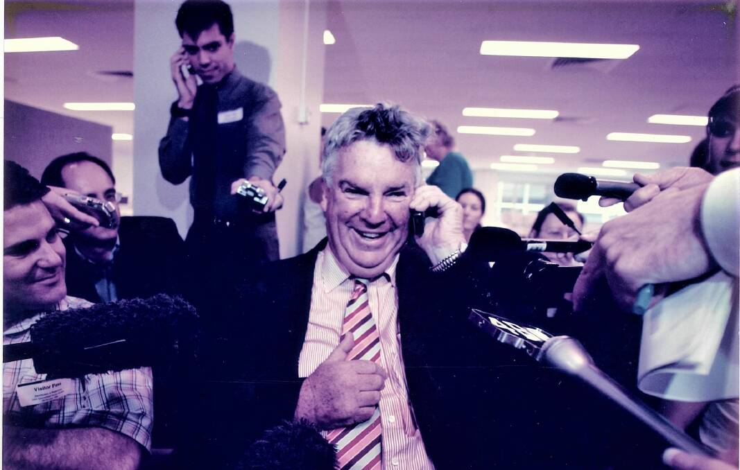 Ron Boswell delivering news of a Senate election win to John Howard, enabling Coalition control of both houses of parliament. Picture supplied.
