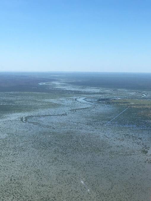 An aerial view of Newcastle Waters Creek in flood.