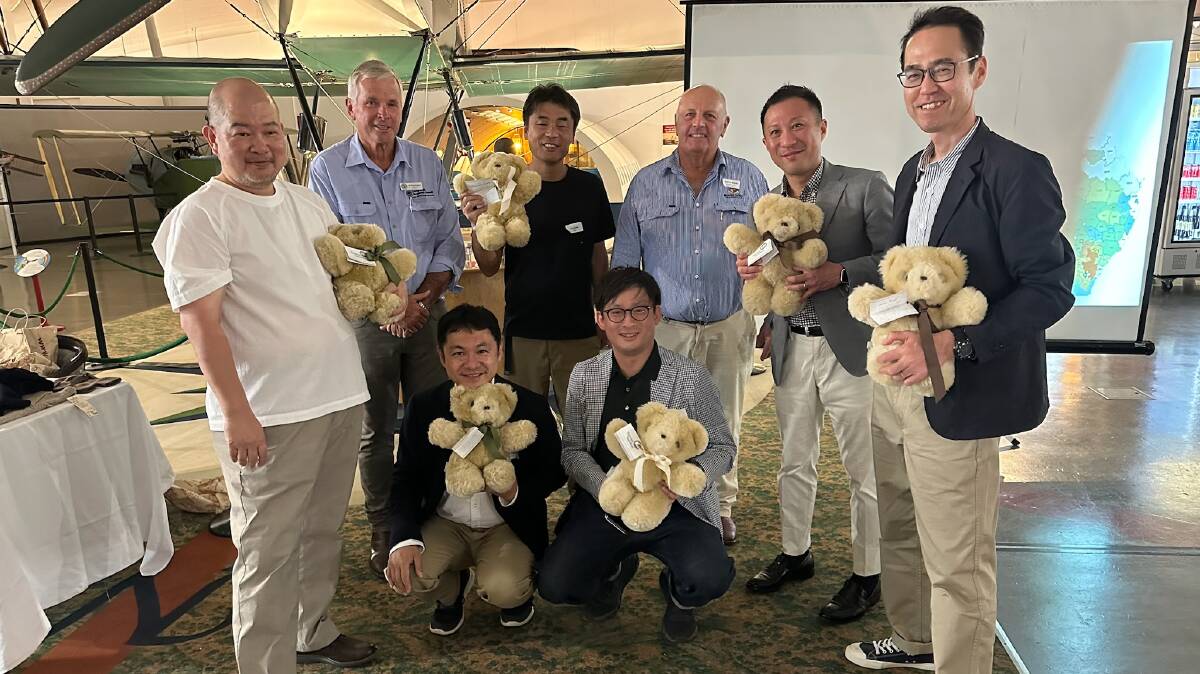 The Japanese wool buying delegation with Longreach and Blackall-Tambo mayors Tony Rayner and Andrew Martin, and the Tambo Teddies they'd been presented with, at the Qantas Founders Museum. Pictures supplied.