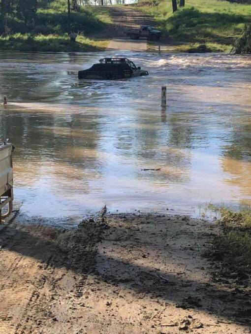 One of the vehicles caught in floodwater at the Isaac River bridge.