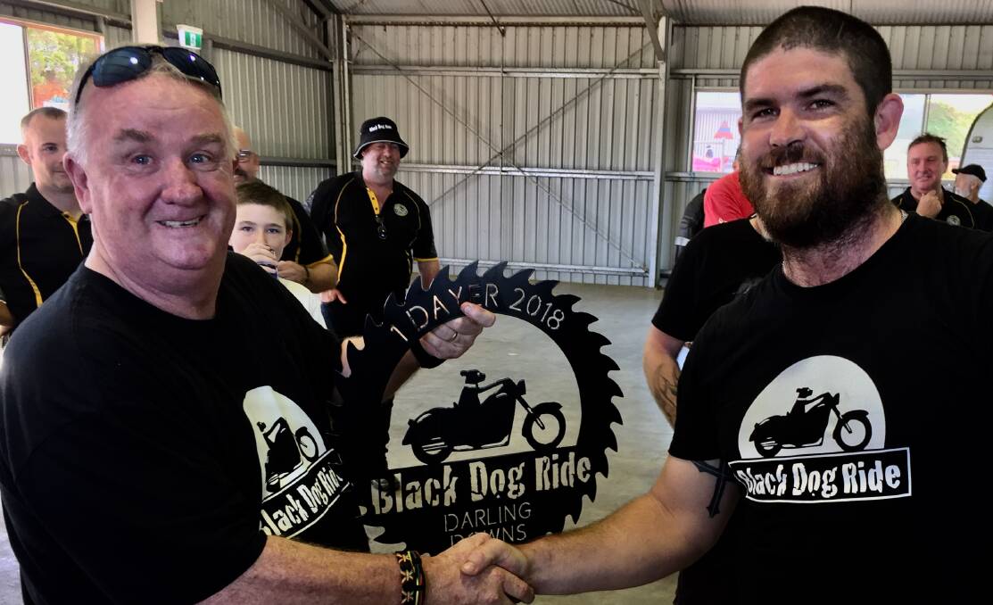 Darling Downs Riders president, Clay Cahill, right, congratulates Dusty Miller on being the first person in Queensland to register for the 2018 Black Dog Ride.