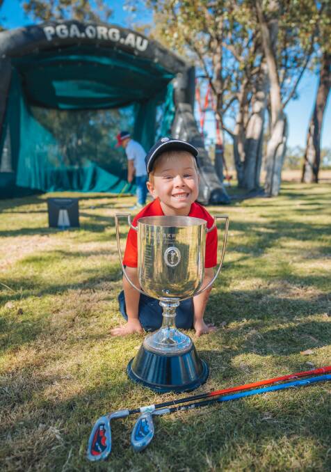 Roma's Alfie Ruhle eyes off the Kirkwood Cup, presented to the winner of the Australian PGA championship, Picture: Reuben Nutt