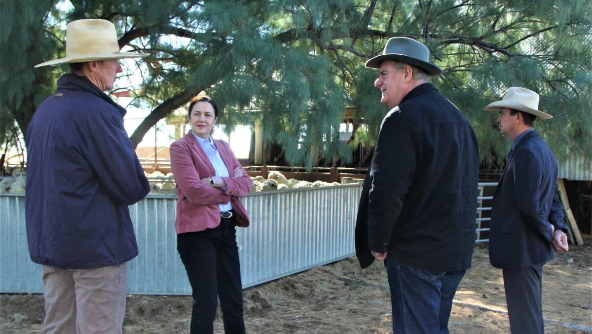 Barcaldine grazier David Counsell, far left, and mayor Sean Dillon, far right, discuss the employment opportunities brought about by cluster fencing projects to date with Premier Annastacia Palaszczuk and Agriculture Minister Mark Furner, in Barcaldine in June.