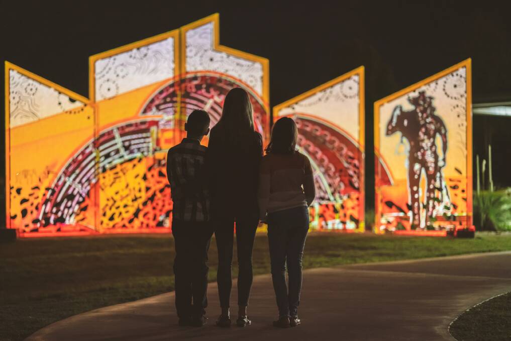 Visitors at Eidsvold's award-winning illuminated Language of the Land sculpture. Picture - Nathan White Images.