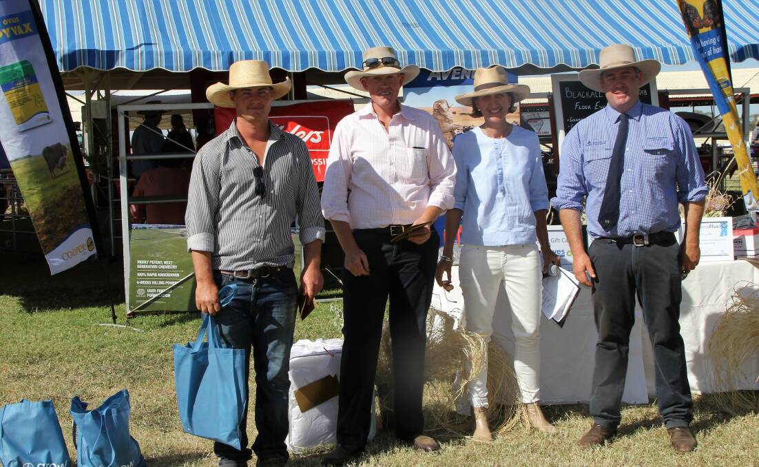 Alex Turnbull, Narada, Tambo, collecting the Lloyd Wood Memorial trophy for champion ewe of the Blackall show from stewards Dominic and Megan Mohr and judge Angus Munro.