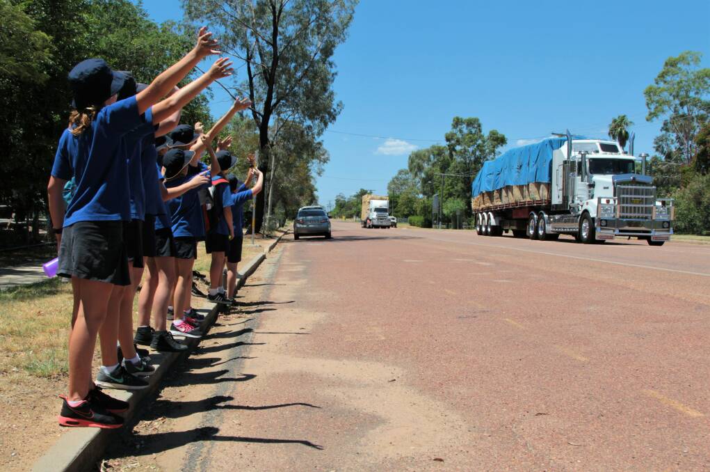 You're welcome: Western Queenslanders, such as these Blackall school students, have been happy to see the generosity of donated hay roll into their towns. Picture: Sally Cripps.