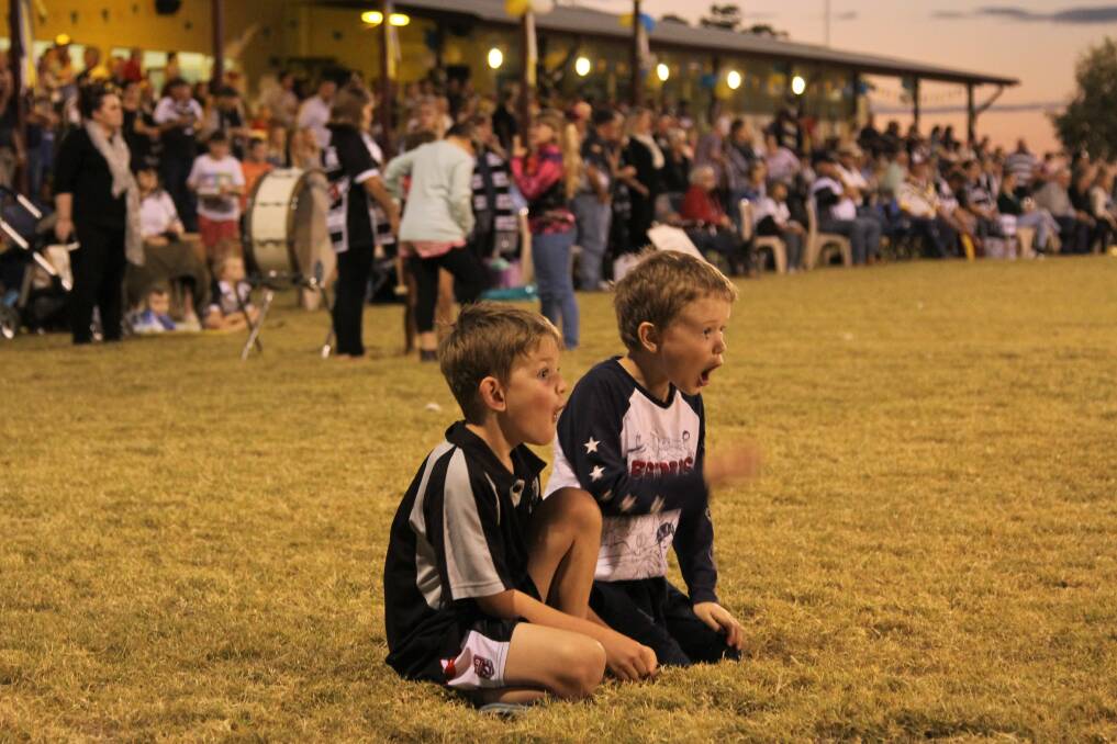 Oblivious to the huge crowd at the Ilfracombe sports oval, these two junior Magpies were absorbed in the grand final action.