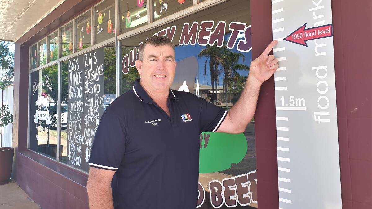 Murweh Shire Mayor Shaun 'Zoro' Radnedge has a permanent reminder of the height of the flood on the side of his butcher shop. Picture - Sally Gall.