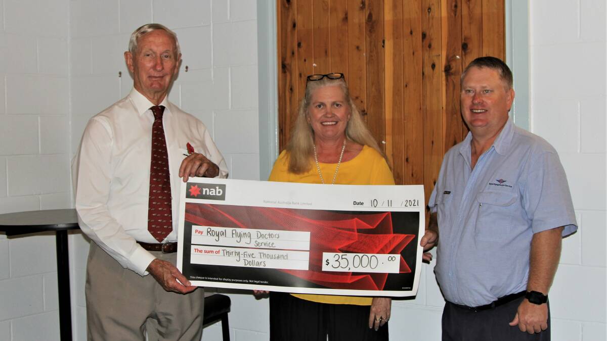 Mystery Ball committee member Kayleen Hall, centre, presents the cheque to Royal Flying Doctor Service Queensland section board member Bruce Scott and Roma RFDS team leader Matt Joppich. Picture: Sally Gall