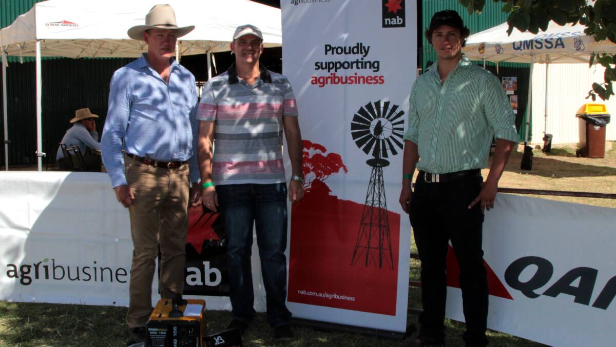 High five: Longreach wether trial steward Doug Allpass and NAB Agribusiness representative Damien O'Rourke congratulate Harry Peacey for Laidlaw's highest wool value team. Pictures: Sally Cripps.
