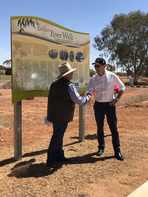Maranoa MP, David Littleproud shakes hands with Bulloo Shire Council mayor, Tractor Ferguson at the opening of the Bulloo River Walk.