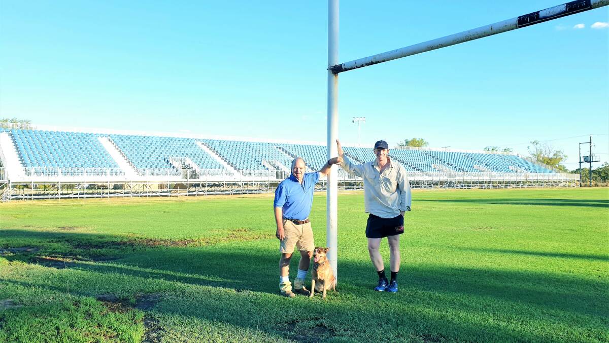 Roma Rugby's David Hickey and Wallumbilla grazier Hugh Scott, along with help from Tess the dog, putting some finishing touches to the grounds, with the new 2500-seat grandstand behind them. Picture: Sally Gall