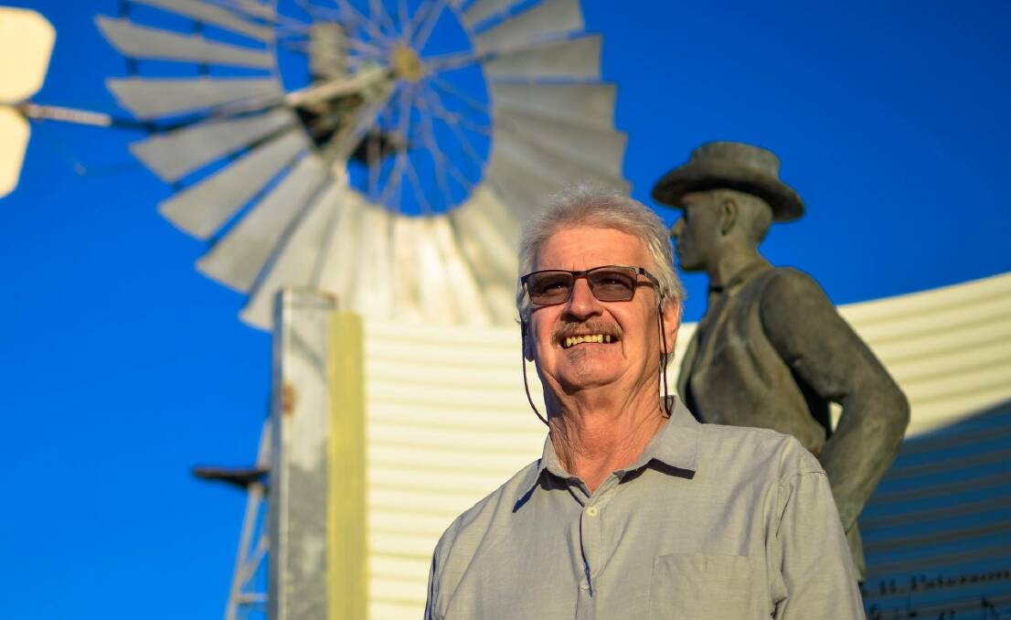 Butch Lenton pictured beside the statue of Banjo Paterson, which survived the 2015 Waltzing Matilda Centre fire. Photo - Ash Moore.