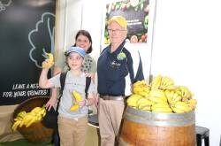 Steven Samios and his mother Maria Samios, West End, with Tully banana grower Len Collins at the Queensland Fruit and Vegetable stand at the Ekka. Picture: Sally Gall
