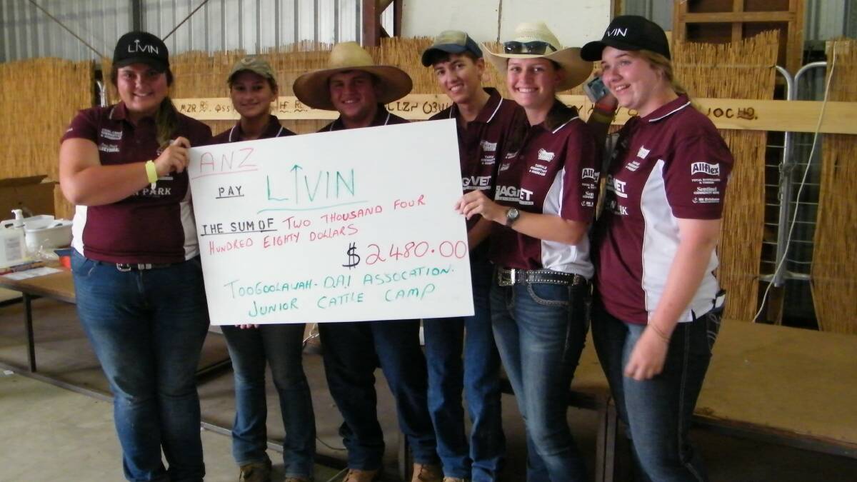 The organising committee and a mock-up of the cheque to present to Livit.
