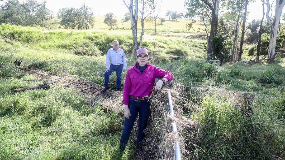 Steve Turner and daughter Carly Turner, Y3K Brahmans, Calgoa, are discovering the full extent of the damage to their fencing. Picture: Lucy Kinbacher
